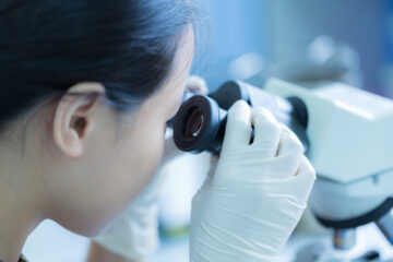 Student working with a microscope